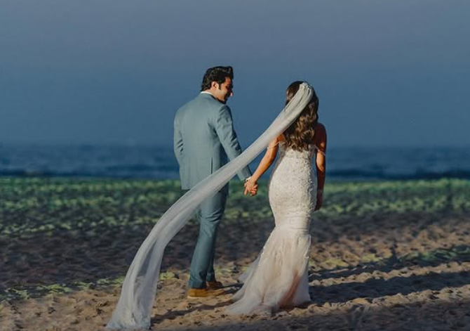 Aadar Jain and Alekha Advani walk down the beach